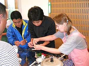 Participants try Russian cooking at a seminar.